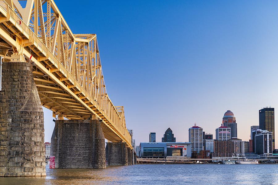 About Our Agency - View of Louisville from below a Yellow Bridge across the Ohio River