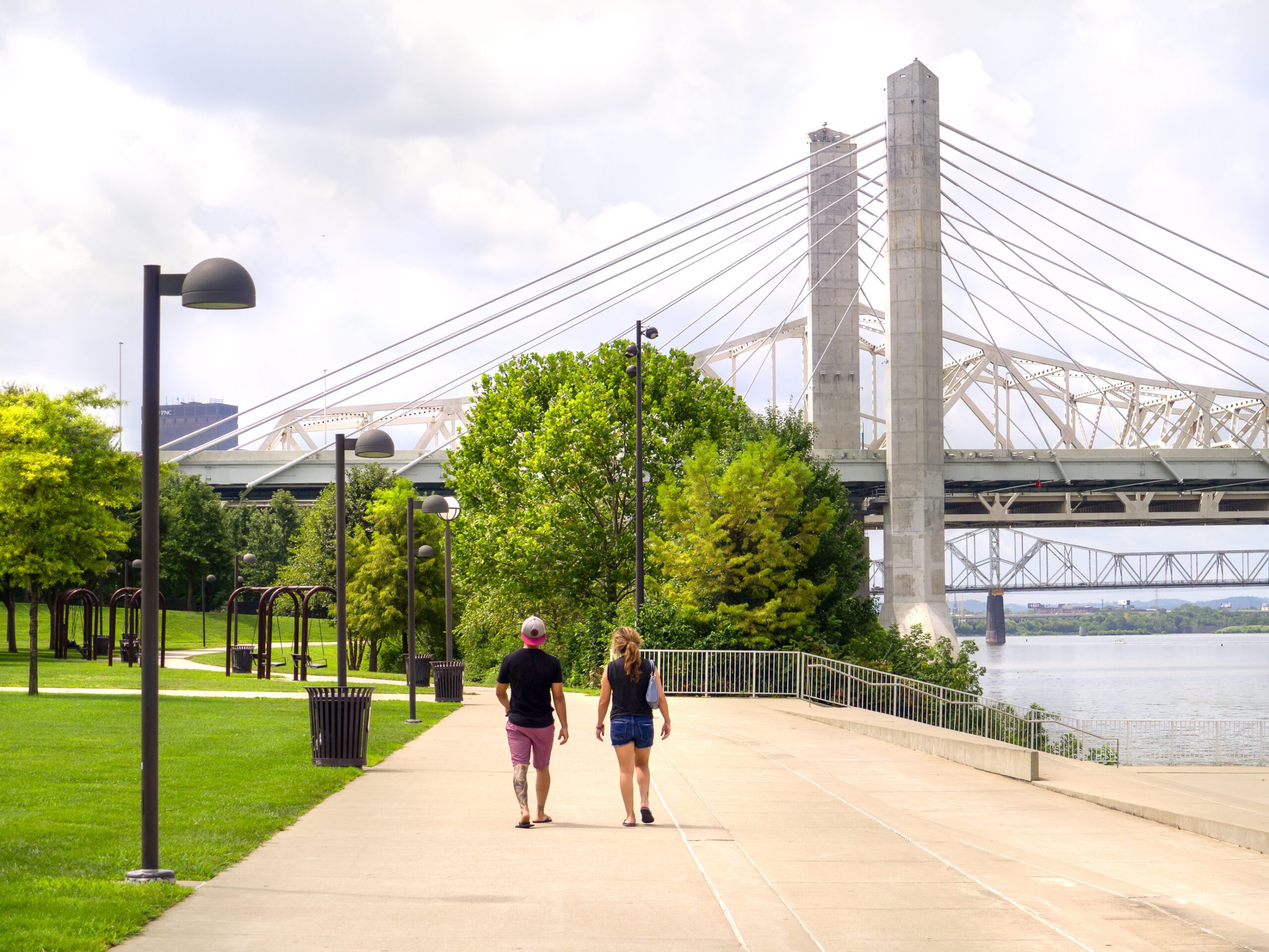 Contact Us - Louisville, KY Waterfront, People Walking along the Wide Sidewalks, Bridge up Ahead